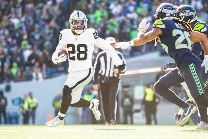 Nov 27, 2022; Seattle, Washington, USA; Las Vegas Raiders running back Josh Jacobs (28) rushes against the Seattle Seahawks during the first quarter at Lumen Field. Mandatory Credit: Joe Nicholson-USA TODAY Sports